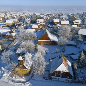Winter village with snow-covered roofs and half-timbered buildings