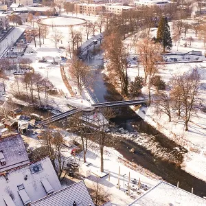 Wintery cityscape with river and bridge