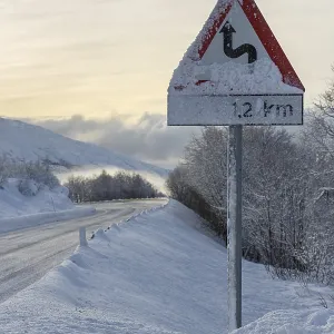 Wintry road with warning sign, European route E10
