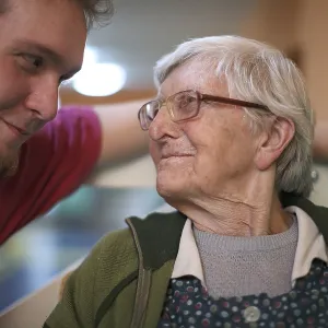 Woman, 89 years, talking to a nurse for the elderly