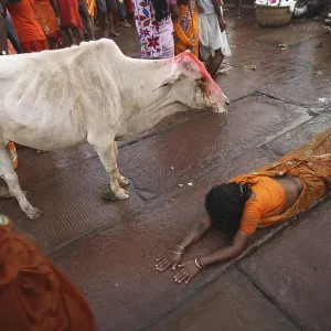 Woman bowing down to god srabani purnima