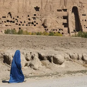 Woman in Burkha before the great buddhas in Bamyan Woman in Burkha before the great buddhas in Bamyan
