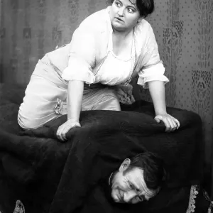 Woman hiding man in sofa, 1920s, Germany, Europe Woman hiding man in sofa, 1920s, Germany, Europe