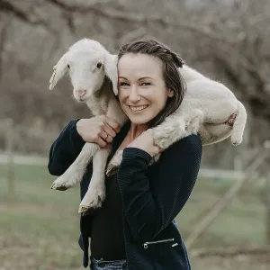 Woman with lamb on her shoulders, Austria Woman with lamb on her shoulders, Austria