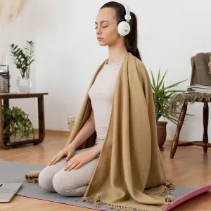 Woman meditating home with headphones Woman meditating home with headphones