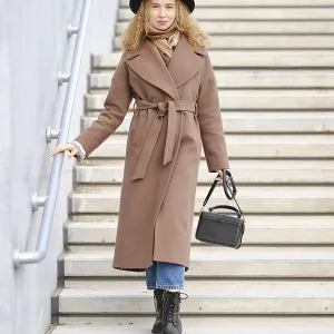 A woman walks down a set of steps in an urban location A woman walks down a set of steps in an urban location