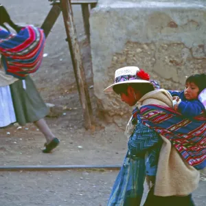 Women carrying bundles and toddlers
