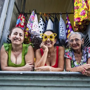 Three women looking out of a window in Lapa