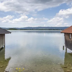 Wooden Boathouses on a Calm Bavarian Lake Print