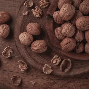 A wooden bowl holds many walnuts A wooden bowl holds many walnuts