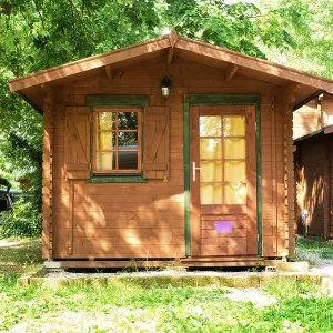 Wooden bungalows on campsite camping. Green trees Wooden bungalows on campsite camping. Green trees
