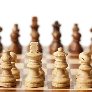 Wooden chess pieces on chessboard Wooden chess pieces on chessboard