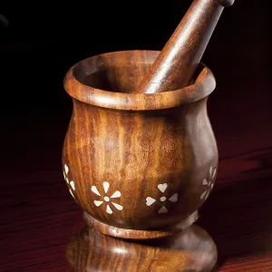Wooden mortar and pestle on dark wood background Wooden mortar and pestle on dark wood background