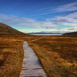 Wooden path in the open-air museum of Forsol towards the bay