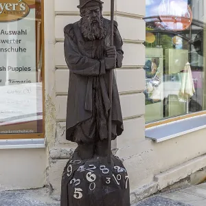 Wooden sculpture of Adam Ries as an arithmetic with numbers
