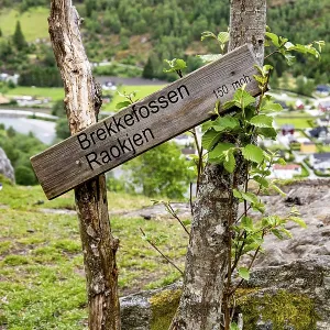 Wooden signpost for Brekkefossen waterfall in the Norwegian mountains