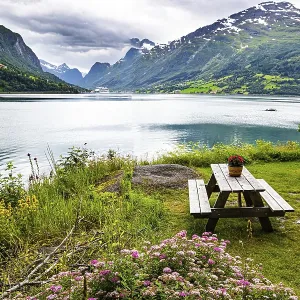 Wooden table and benches on the banks of the picturesque Lovatnet