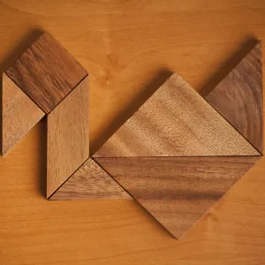 A wooden tangram puzzle arranged to resemble a bird