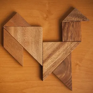 A wooden tangram puzzle arranged into a rooster shape