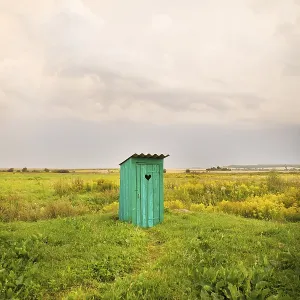 Wooden toilet with a carved window in the shape of a heart Wooden toilet with a carved window in the shape of a heart