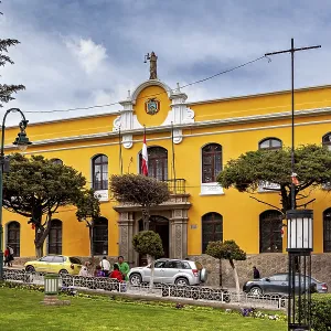 Yellow building with flags in an urban environment Yellow building with flags in an urban environment