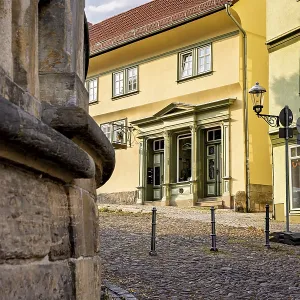 Yellow historic building on a paved street with classic architecture Yellow historic building on a paved street with classic architecture