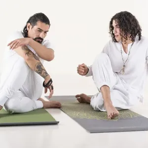A yoga instructor is teaching yoga to a young man A yoga instructor is teaching yoga to a young man