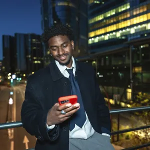 Young black businessman on an elevated walkway at night Young black businessman on an elevated walkway at night
