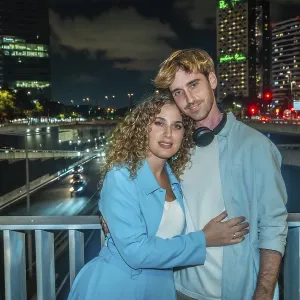 Young Couple Embracing on Urban Bridge Print at Night