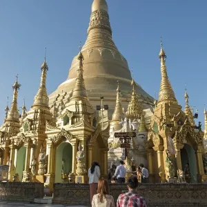 Young couple praying at Shwedagon Pagoda