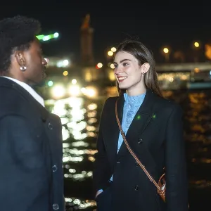 Young diverse couple standing by paris river at night Young diverse couple standing by paris river at night