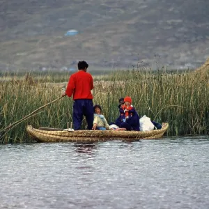 Young family with young children in a reed boat
