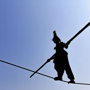 Young girl balancing on rope, balancing act