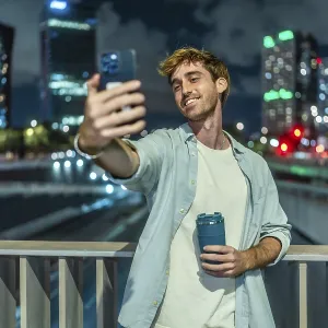 Young Man Taking a Selfie on a City Bridge Print