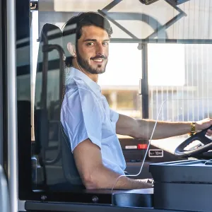 Young man working as a bus driver