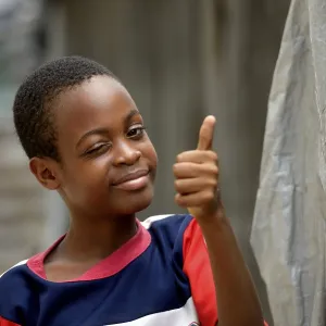 Young winking and giving his thumbs up