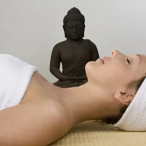 Young woman next to a Buddha statue Young woman next to a Buddha statue