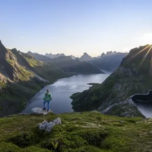 Young woman looking over fjord landscape Young woman looking over fjord landscape