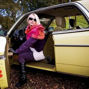 Young woman in a post-war classic car