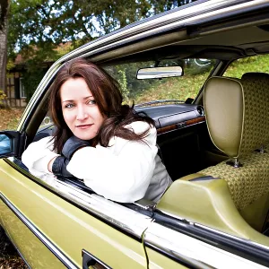 Young woman in a post-war classic car