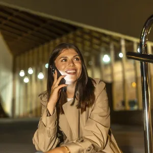 Young woman sitting outdoors at night Young woman sitting outdoors at night