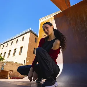 Young Woman Squatting Print - Urban Scene