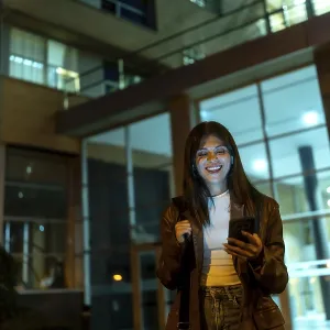 Young woman standing on a city street at night Young woman standing on a city street at night