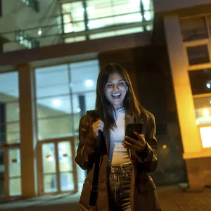 Young woman standing on an urban street at night Young woman standing on an urban street at night