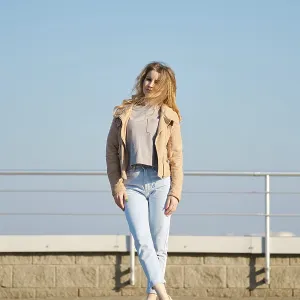 A young woman stands on a modern rooftop terrace