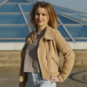 A young woman stands proudly outdoors