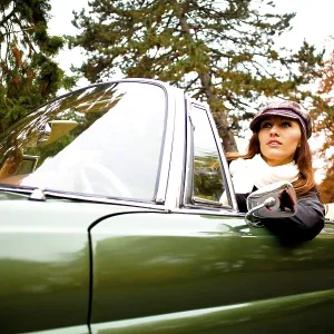 Young woman in a vintage car, MB 220 SE Cabriolet Young woman in a vintage car, MB 220 SE Cabriolet