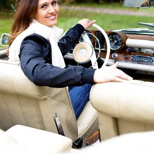Young woman in a vintage car, MB 220 SE Cabriolet Young woman in a vintage car, MB 220 SE Cabriolet