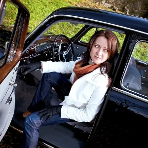 Young woman in a vintage MB vehicle