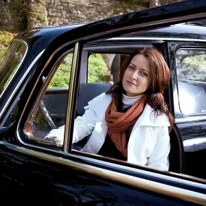 Young woman in a vintage MB vehicle